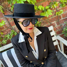 Load image into Gallery viewer, Carlisle Hats Spanish Racing Hat with a wide brim, woven straw design, and decorative band for stylish racing events.
