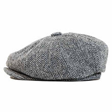 Load image into Gallery viewer, Harris Tweed newsboy cap by Carlisle Hats featuring classic style and textured fabric, worn by a person outdoors.